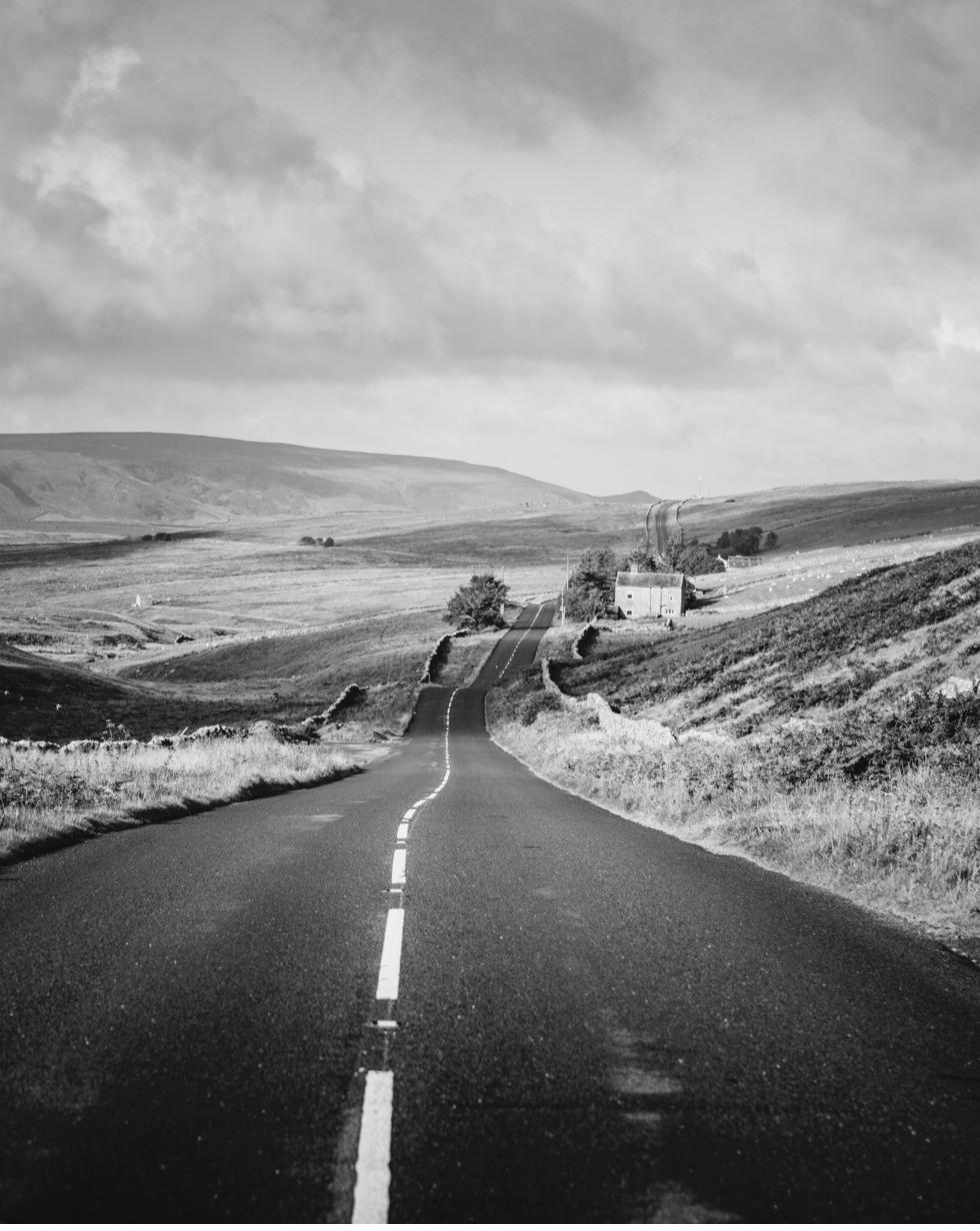 A quiet Yorkshire Dales road leading towards the horizon